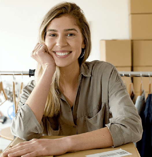 smiling woman business owner packing up her product
